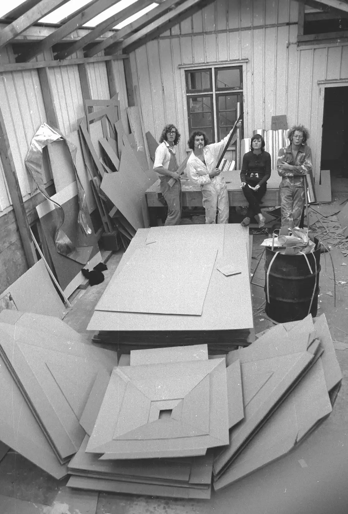 Students cutting and assembling board in a workshop shed at an earlier congress